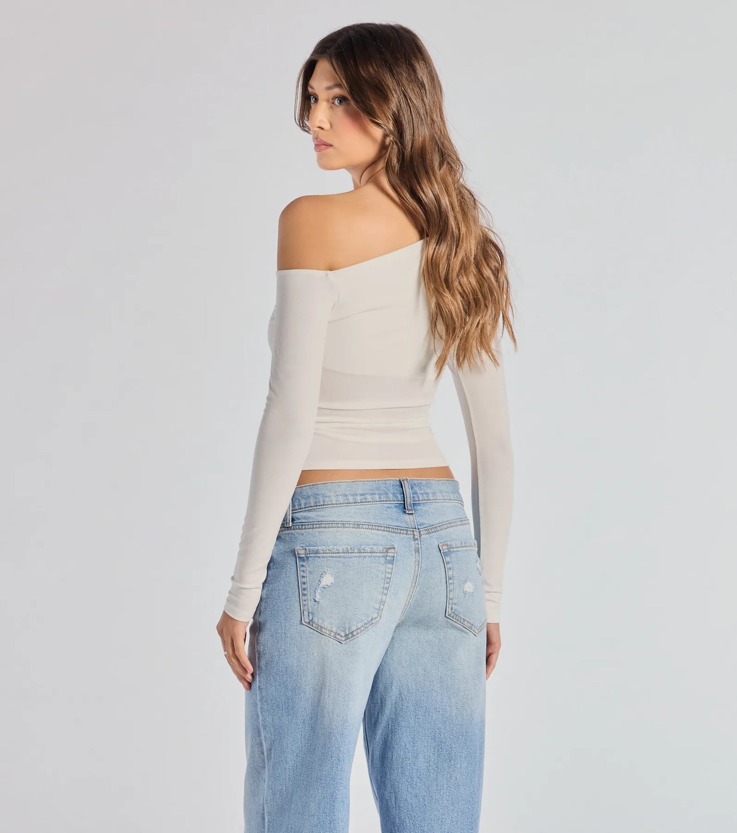 The Chic Factor Asymmetrical Long Sleeve Crop Top in ivory with a modern design and trendy look is part of the latest women's tops collection to elevate your 2025 wardrobe.